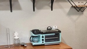 A kitchen with a wooden countertop, a toaster oven, and a 'Welcome' sign on the wall. - #28 Little Belleview by Joyful Moments Vacation (Port Richey)