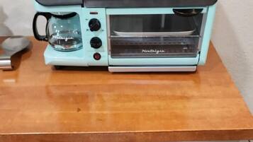 Microwave, coffee/tea maker, toaster, dining tables