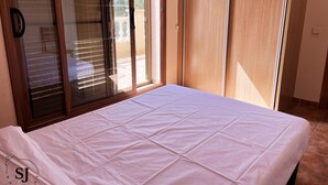 A bedroom with a bed, sliding glass doors, and a view of the outdoors. - Pleasant villa with pool (A) (Ametlla de Mar (Les Tres Cales))