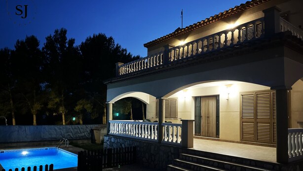 A two-story house with a swimming pool, stone steps, and a balcony with railings. - Pleasant villa with pool (A) (Ametlla de Mar (Les Tres Cales))