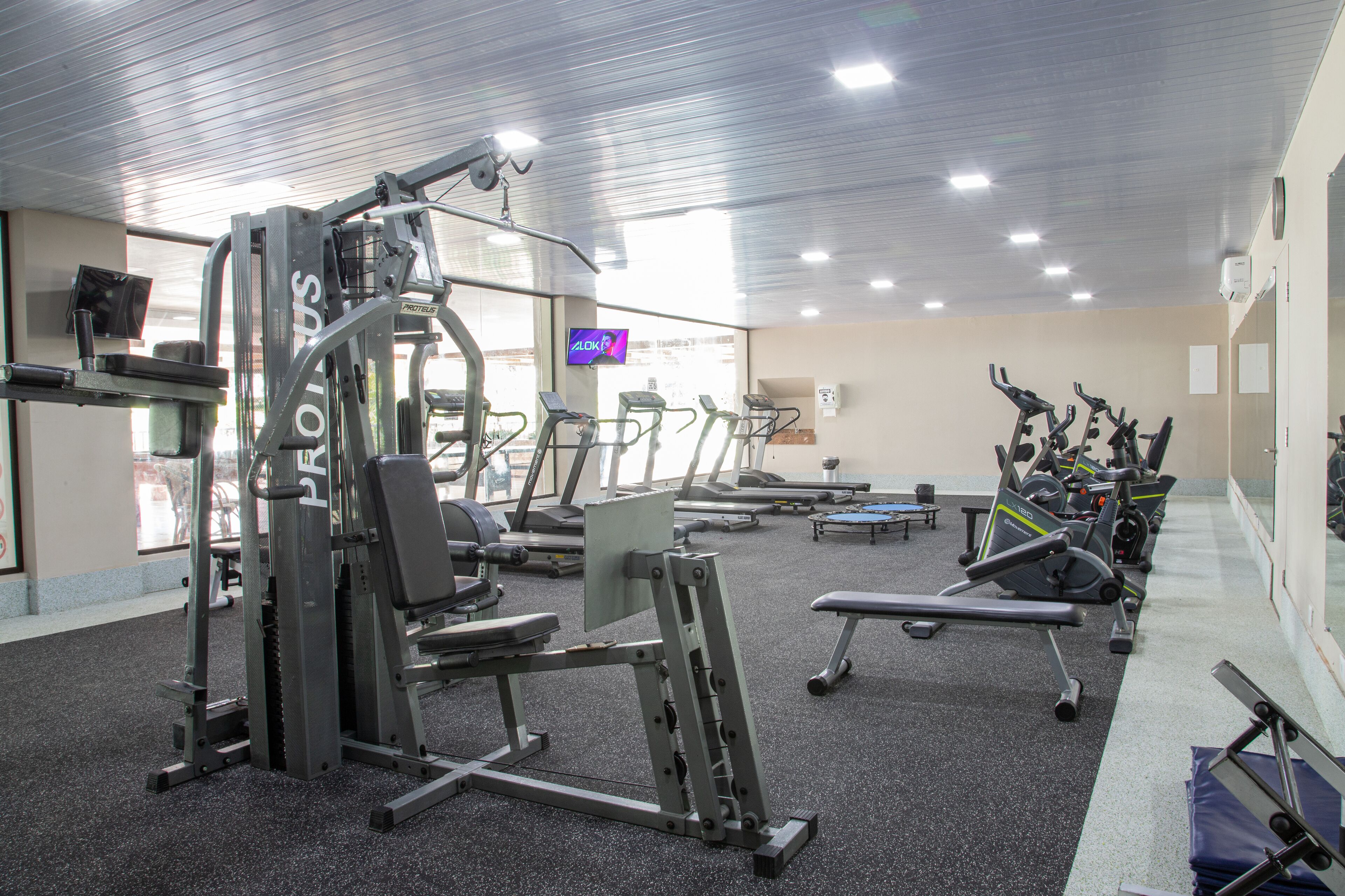 A gym with various exercise equipment, including treadmills and weight machines.