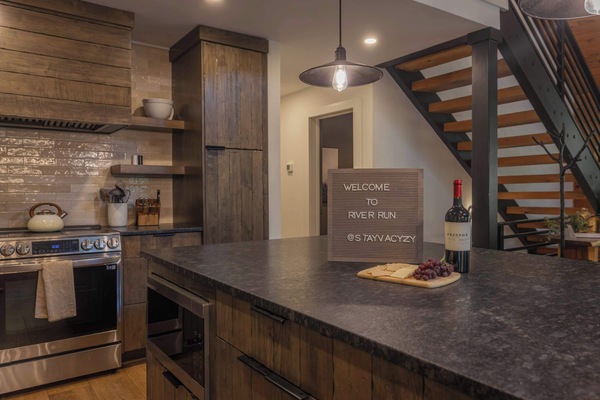 A fully stocked chef's kitchen with a Samsung suite — French-door refrigerator, 36" range, and dishwasher. River Run makes feeding a crew of 14 genuinely enjoyable.