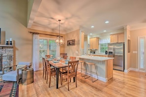 Enjoy meals in the kitchen with a central island and dining area featuring a table and chairs.