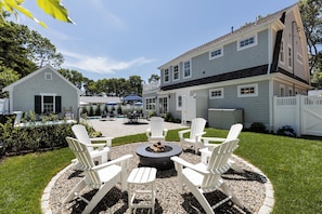 A backyard with a fire pit, outdoor seating, and a pool. - Popponesset, Exclusive, 3-Bdrm, 4-Bths, Sleeps 6, pool, hot tub, firepit, A/C (Mashpee)