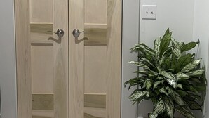 A wooden double door with a handle and a potted plant beside it. - Hidden Gem in plain sight! Adorable 3 Bdrm Duplex near Hospitals & Universities. (Cincinnati)