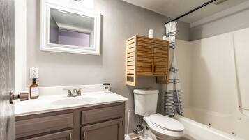 Bathtub, towels, soap, toilet paper