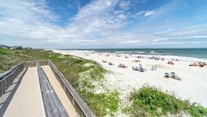 A beach with a wooden boardwalk leading to the shore, sandy beach, and ocean. - Amazing 3BD 1st Floor Pawleys Island at True Blue Resort Golf 4 Pools Near Beach (Pawleys Island)