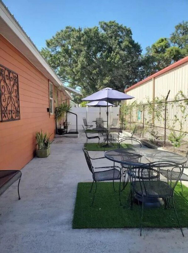 A patio area with outdoor seating and a covered umbrella.