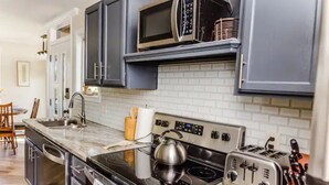 A modern kitchen with stainless steel appliances, a microwave, and a toaster. - The Owl House cheerful, bright, updated 2B A-frame (Hot Springs)
