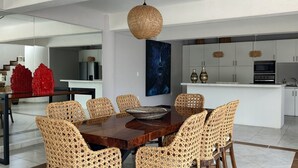 A modern kitchen with white cabinets, a built-in oven, and a stainless steel refrigerator. - Confortable y amplio estudio D9 (Cozumel)