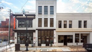 A row of commercial buildings with storefronts, including a visible sign for 'O'Connor's'. - Fabulous Loft w/ King Suite Great Location! (Birmingham)
