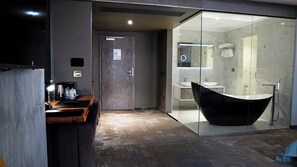 A modern bathroom with a freestanding bathtub, a glass shower enclosure, and a vanity with a large mirror. - Aniroc Signature Hotel (Arad)