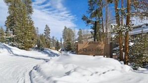 A snow-covered road with a sign for Quicksilver. - North Keystone 1 Bedroom Near Conference Center (Keystone)