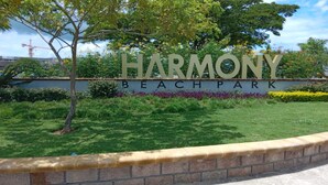 A sign for Harmony Beach Park with a landscaped area in front. - Holiday House at Villa Montego (Montego Bay)