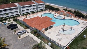 A hotel with a pool area, multiple balconies, and a beach view. - Spacious apartment with sea views, everything you need to spend your vacations. (Isabela)