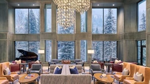 A spacious lobby with large windows, a grand piano, and modern furniture. - Grand Hyatt Vail Hotel Room With King Bed (Vail)