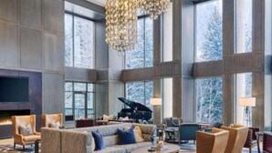 A spacious lobby with a grand piano, comfortable seating, and large windows offering a view of snow-covered trees. - Grand Hyatt Vail Hotel Room With 2 Queens (Vail)
