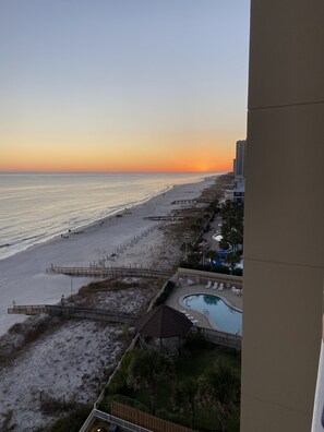A beach view with a pool area and a boardwalk. - Beautiful Condo located on Romar Beach-seconds from beach (Orange Beach)