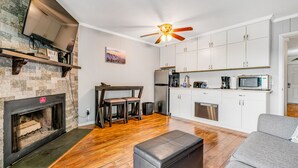 A modern kitchen with white cabinets, a built-in microwave, and a ceiling fan. - Gorgeous condo with hot tub, heated indoor pool, fireplace, balcony, & fast WiFi (Beech Mountain)