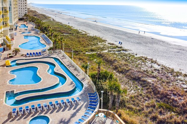 Relax by the resort's interconnected pools and enjoy stunning ocean views from the comfort of your balcony.