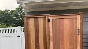 A wooden outdoor storage cabinet with a hinged door and a small step for access. - Cozy House less than two miles from Ocean Beaches (Hampton Bays)