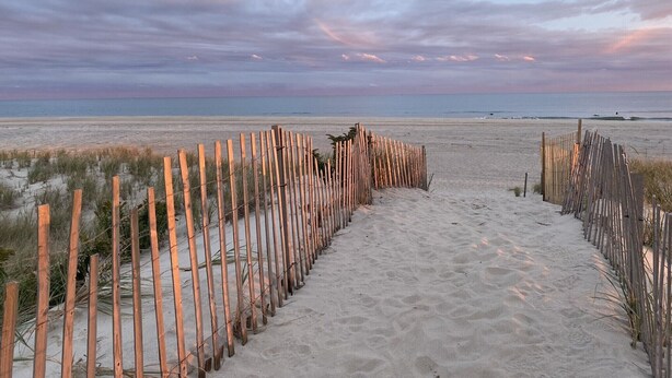 A sandy beach path with wooden fencing leading to the ocean. - Cozy House less than two miles from Ocean Beaches (Hampton Bays)