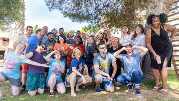 A group of people posing outdoors, likely at a social event or gathering.