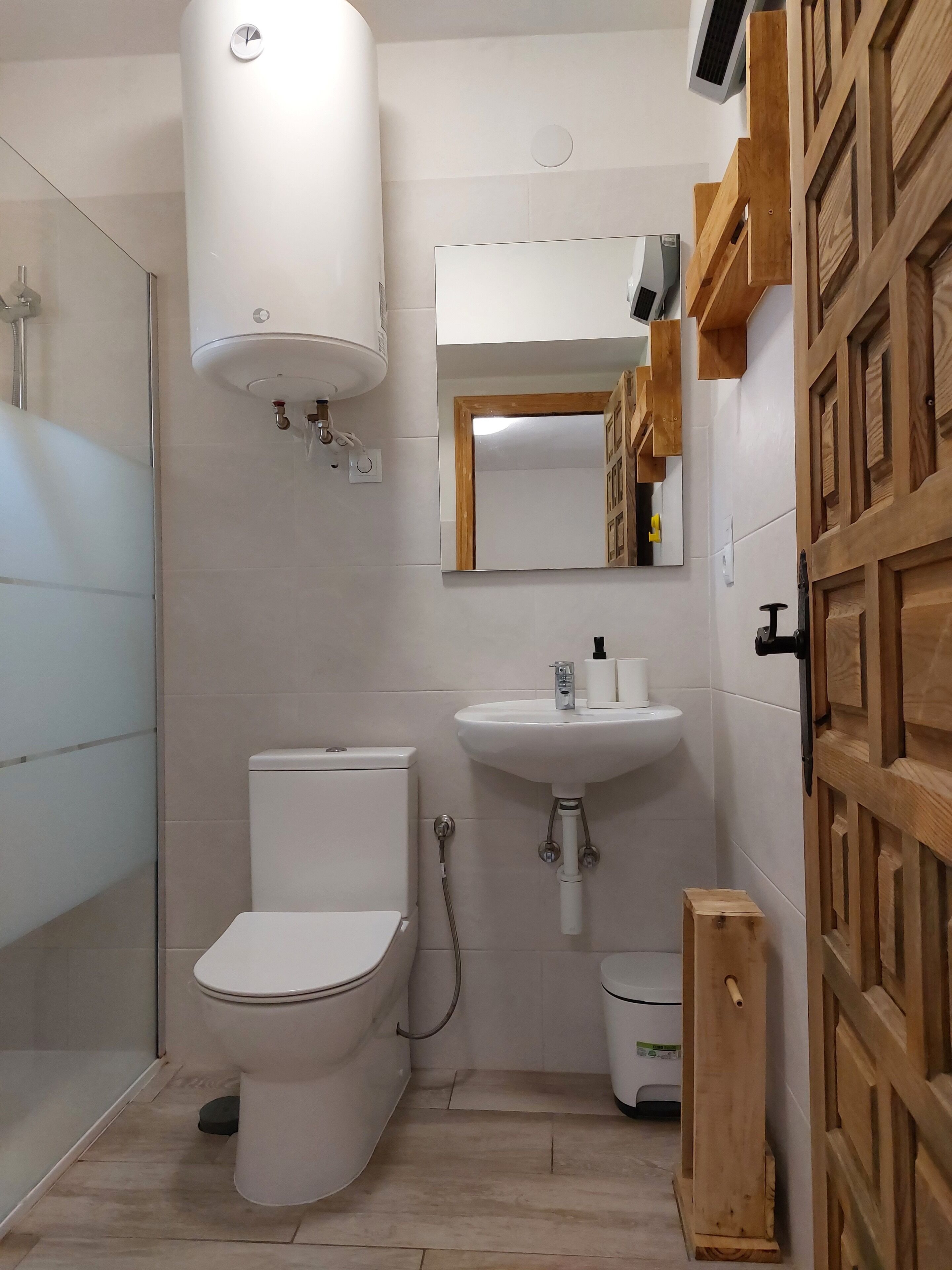 A bathroom with a toilet, sink, and shower.