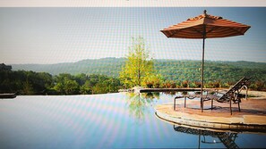 Enjoy a serene mountain view from the poolside lounge area, where you can relax and unwind.