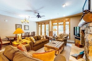 A spacious living room with a sofa set, a coffee table, a fireplace, and a television. - 2 Bedroom Ski-in, Ski-out Condo at The Timbers (Keystone)