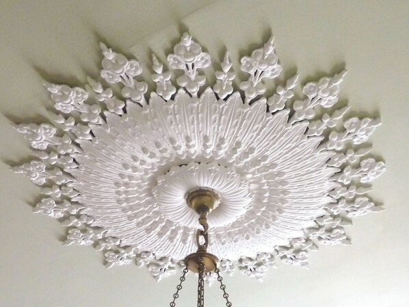 A ceiling with a decorative, radial pattern.