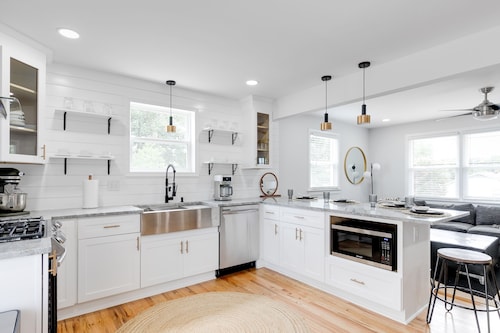 Stylish 4 bedroom house with outdoor dining and fenced backyard.