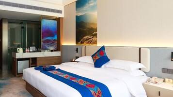 A hotel room with a large bed, a desk, a mirror, and a painting on the wall.