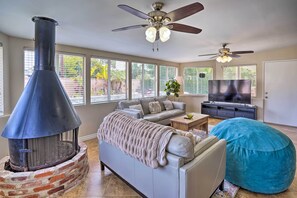 A living room with a fireplace, a sofa, a TV, and a ceiling fan. - Quiet Anaheim Home w/ Pool, 5 Mi to Disney! (Anaheim)