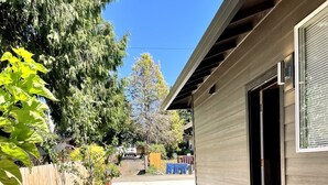 A modern house with a concrete pathway leading to the door, surrounded by a wooden fence and gravel. - New Guest Suite 2br/1bth in DT Vancouver - pet friendly (Vancouver)