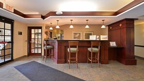 A reception area with a counter, three bar stools, and a door marked 'EXIT'. - 1-Bedroom | Top Location | Pool, Hot Tub Access (West Des Moines)