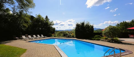 Seasonal outdoor pool, open 9:00 AM to 9:00 PM, pool umbrellas