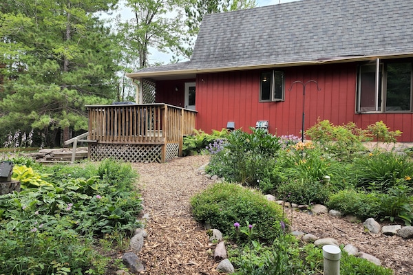 Peaceful perennial gardens surround one side.