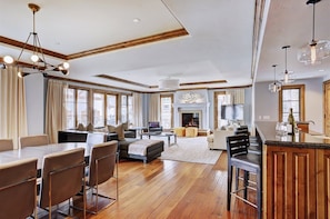 Relax in this inviting space with a dining table, sofas, and fireplace.