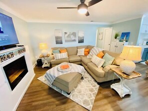 Relax in this inviting living room with a comfortable sofa, coffee table, and flat-screen TV.