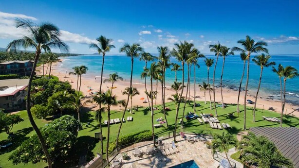 A resort with a pool, lounge chairs, and a beach view. - Tracy's Tropical Treasure #3 earned "Best in Kihei" four times and “#1 in Maui” (Kihei)