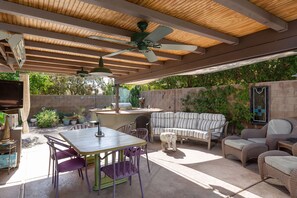 An outdoor patio with a table and chairs, a sofa, and a ceiling fan. - 3 Bedroom 2 Bath Pool/Spa Home in Quite neighborhood. (La Quinta)