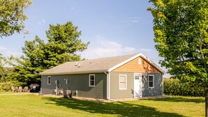 A single-story house with a gabled roof, a front door, and a small porch area.