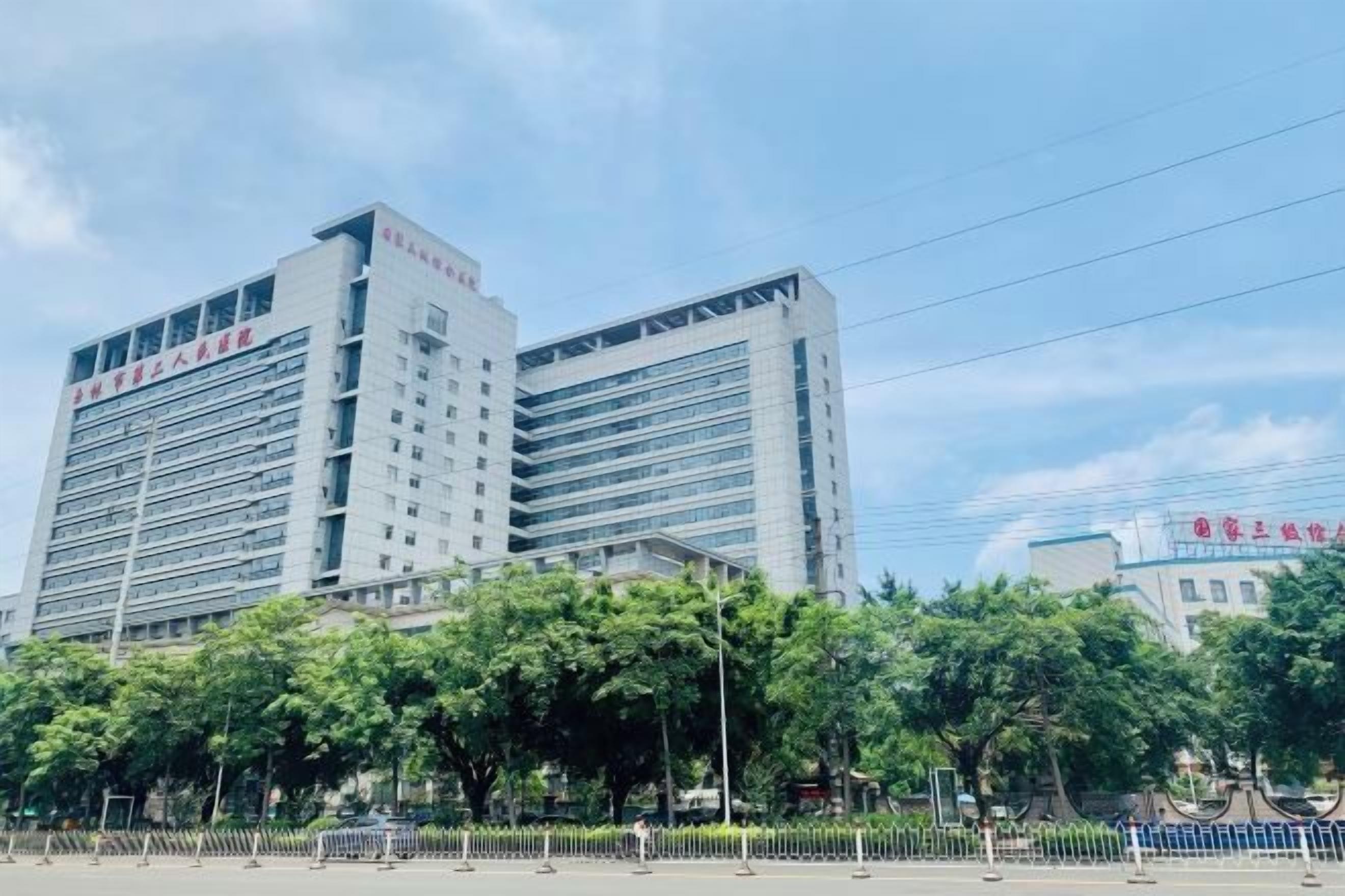 A multi-story building with a modern architectural design, featuring a prominent entrance and a series of windows.
