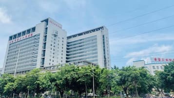 A multi-story building with a modern architectural design, featuring a prominent entrance and a series of windows.