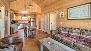 A spacious wooden interior with a dining area, sofa, and kitchen. - Dreamy Mountain-View Cabin Near Yellowstone! (Livingston)