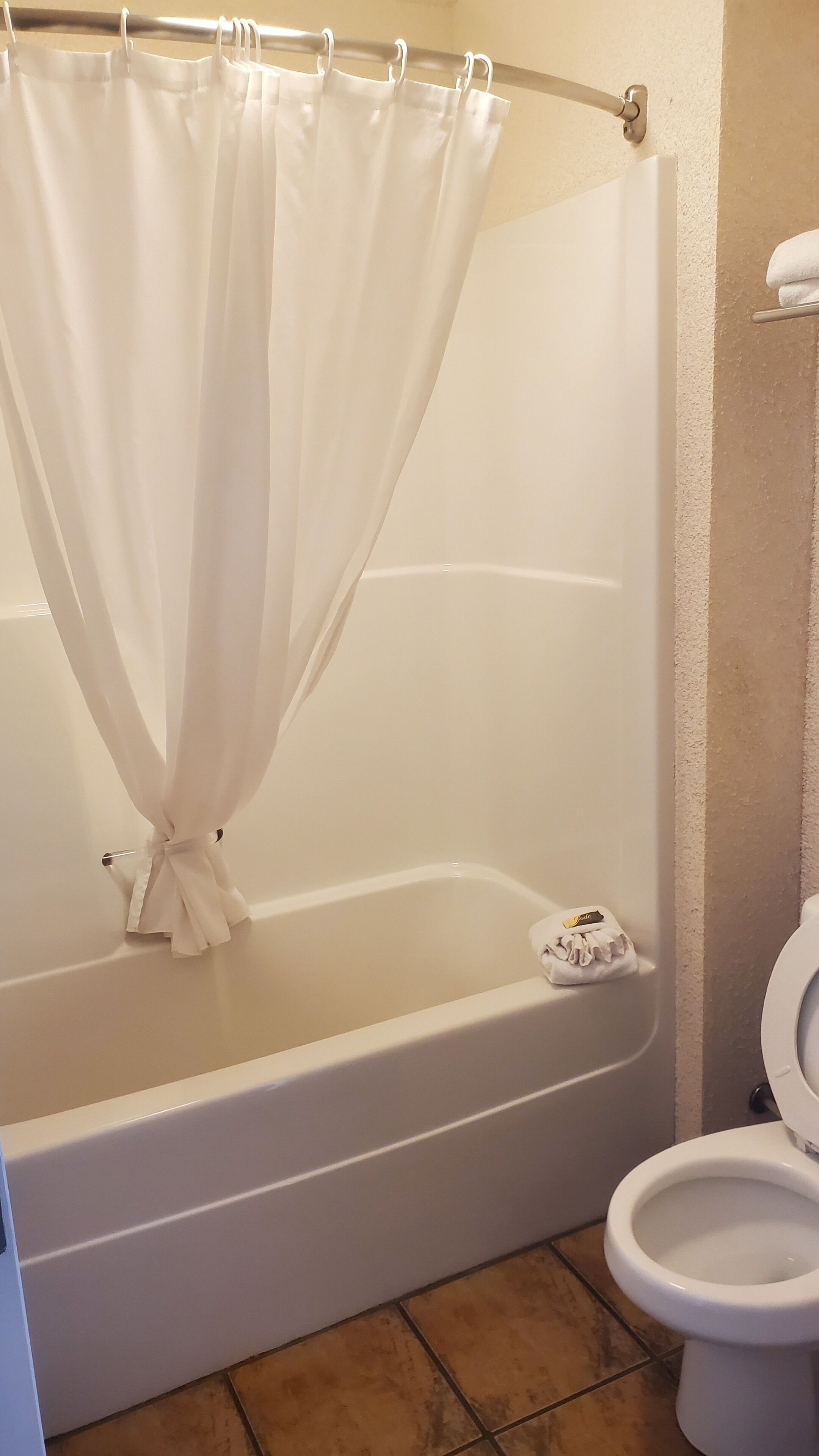 Bathtub, designer toiletries, towels, soap