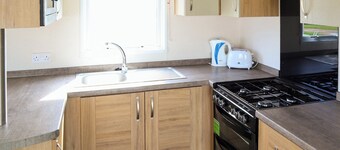 Comfortable modern 12ft-wide caravan with one double and two twin.