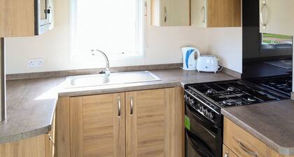 Comfortable modern 12ft-wide caravan with one double and two twin.