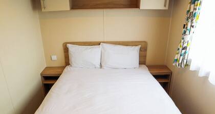 Comfortable modern 12ft-wide caravan with one double and two twin.
